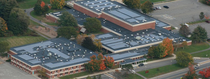 Aerial view of a Newburyport, Massachusetts school with solar panels on its roof