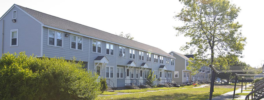 Daytime exterior of a row of houses owned by the Lynn, Massachusetts Public Housing Authority